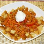 Острый салат с морковью, колбасой и сухариками